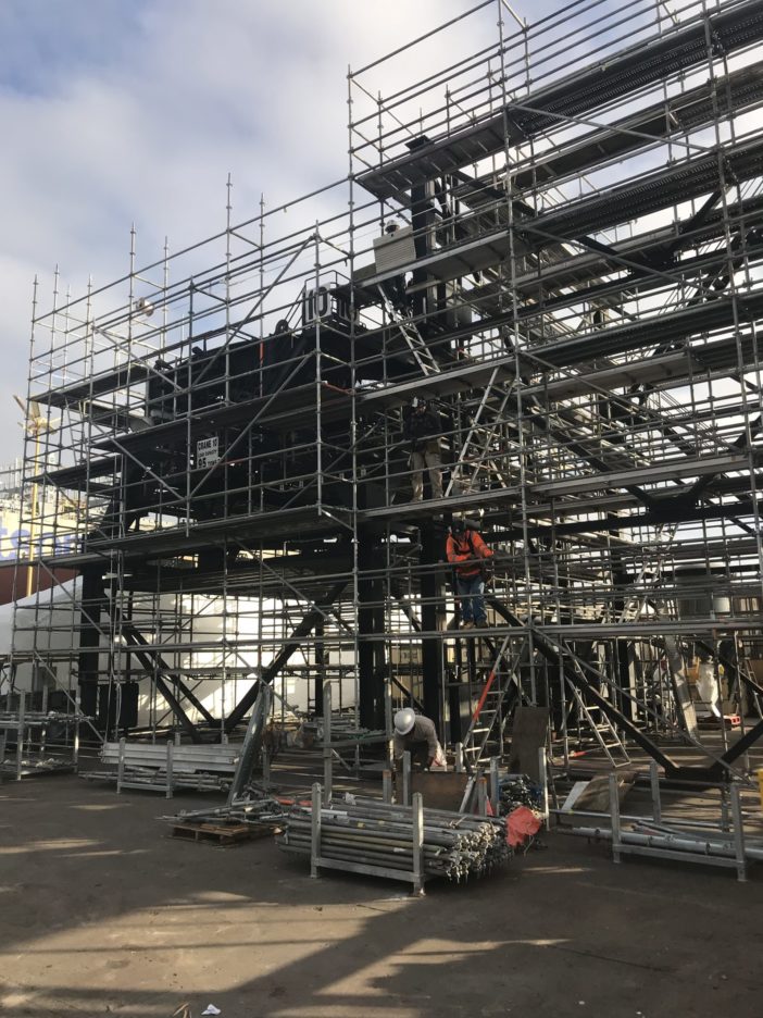 Premier Scaffold, Inc. manufactures a large steel structure equipped with scaffolding.
