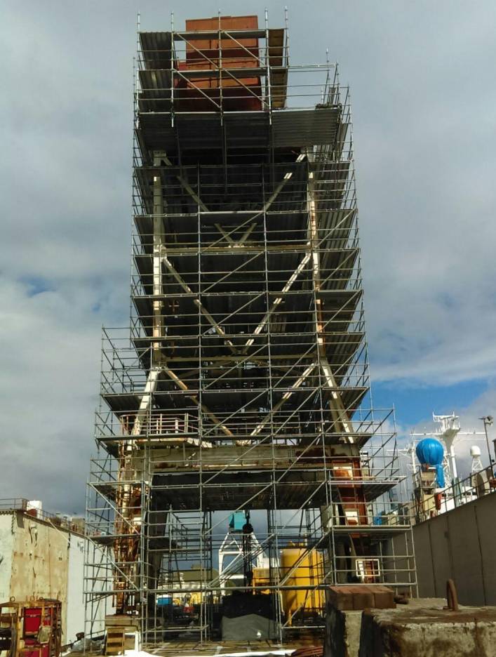 Premier Scaffold is currently constructing a large structure with scaffolding around it.